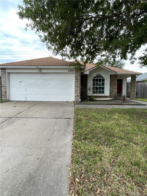 ranch-style house with a front yard and a garage