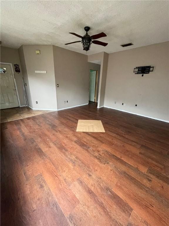 empty room with hardwood / wood-style floors, a textured ceiling, and ceiling fan