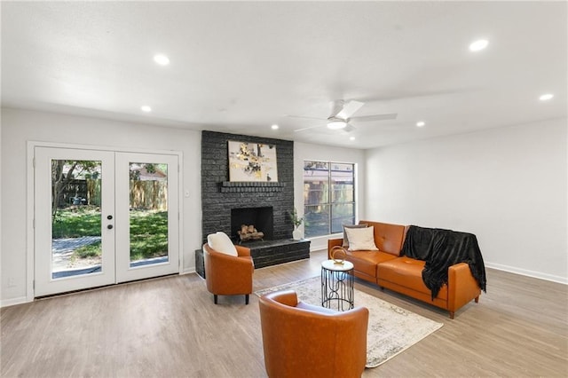 11029 Stonewall Blvd, Corpus Christi, TX 78410 - living room featuring wood finished floors, ceiling fan, recessed lighting, a brick fireplace, and french doors