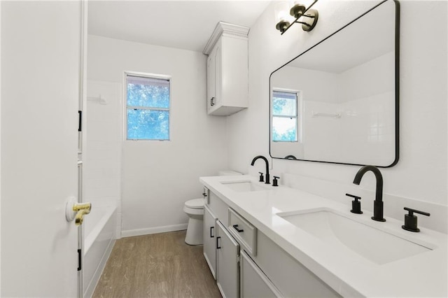 11029 Stonewall Blvd, Corpus Christi, TX 78410 - full bath featuring double vanity, wood finished floors, plenty of natural light, and tub / shower combination