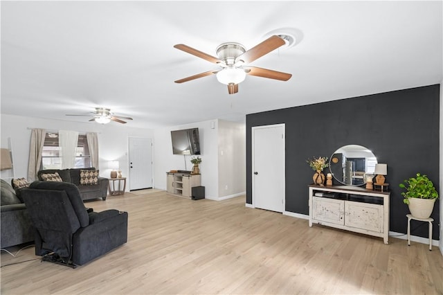 living room featuring ceiling fan and light wood-type flooring