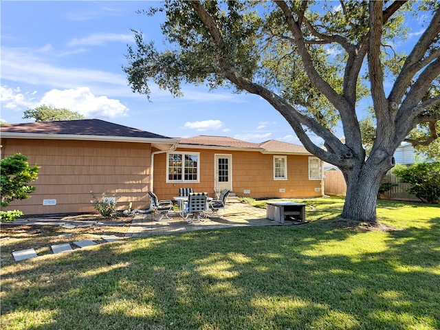 back of property featuring a patio area and a yard