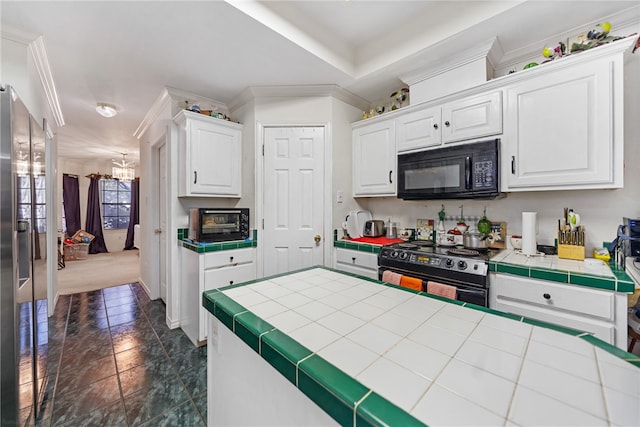 kitchen featuring tile countertops, white cabinetry, black appliances, and a chandelier