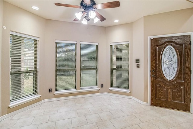 tiled entrance foyer featuring ceiling fan