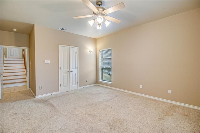 carpeted empty room with ceiling fan