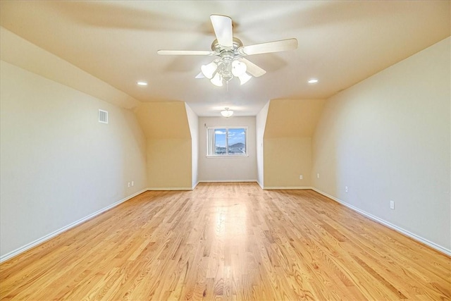 bonus room with ceiling fan and light wood-type flooring