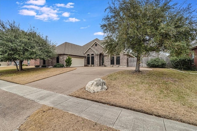 view of front of property with a garage and a front yard