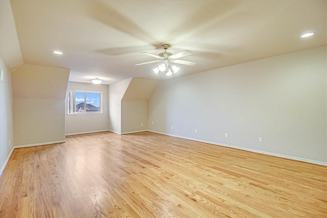 additional living space with ceiling fan, vaulted ceiling, and light hardwood / wood-style floors