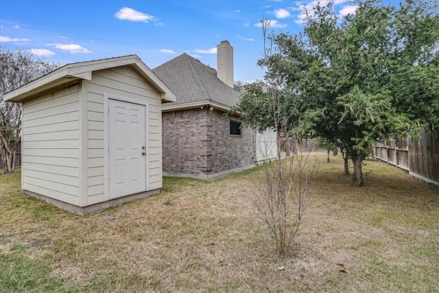 exterior space with a shed and a yard