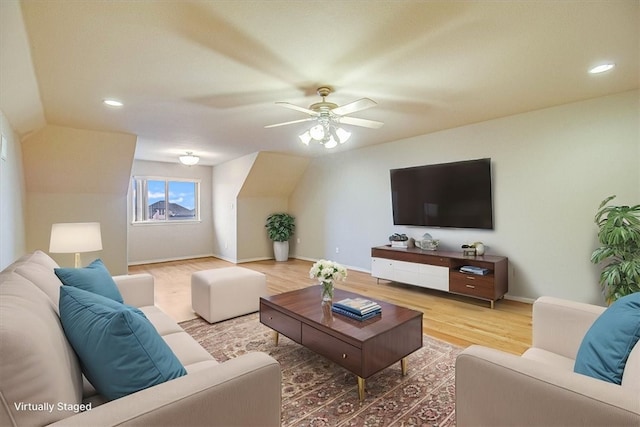 living room with hardwood / wood-style flooring and ceiling fan