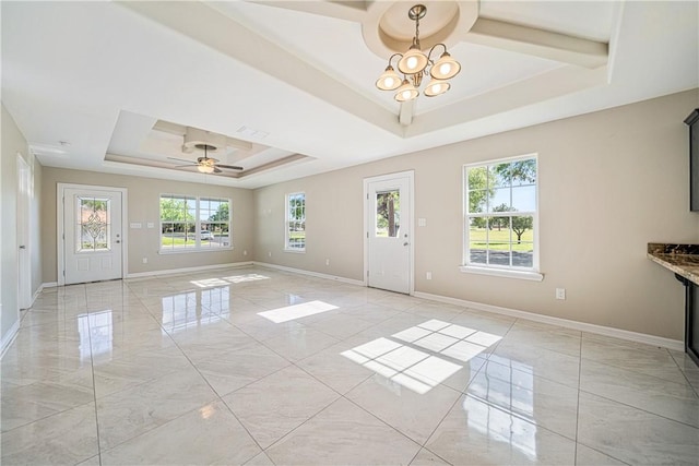 interior space featuring ceiling fan with notable chandelier, a tray ceiling, visible vents, marble finish floor, and baseboards
