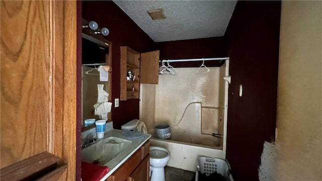 2993 Todd Cir, Ingleside, TX 78362 - full bathroom featuring shower / bathtub combination, toilet, vanity, and a textured ceiling