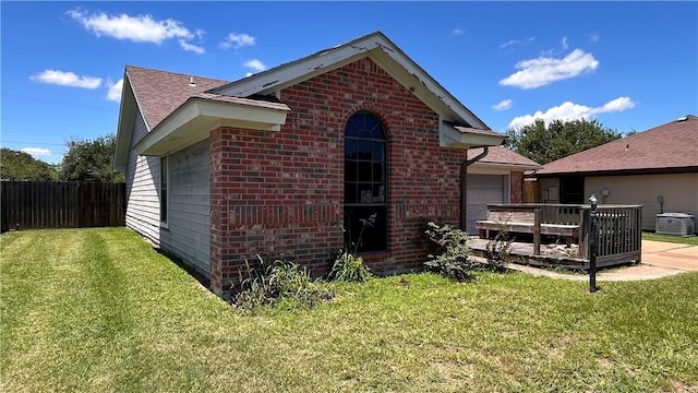 2993 Todd Cir, Ingleside, TX 78362 - back of property with brick siding, central AC unit, a garage, and roof with shingles
