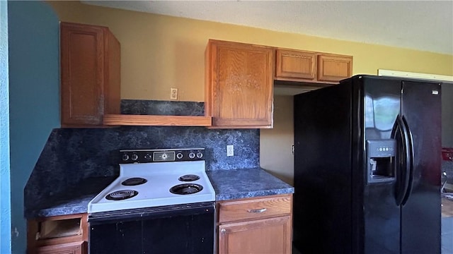 2993 Todd Cir, Ingleside, TX 78362 - kitchen featuring black fridge, white electric range, backsplash, brown cabinets, and dark countertops