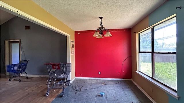 2993 Todd Cir, Ingleside, TX 78362 - dining area featuring plenty of natural light, a chandelier, and a textured ceiling
