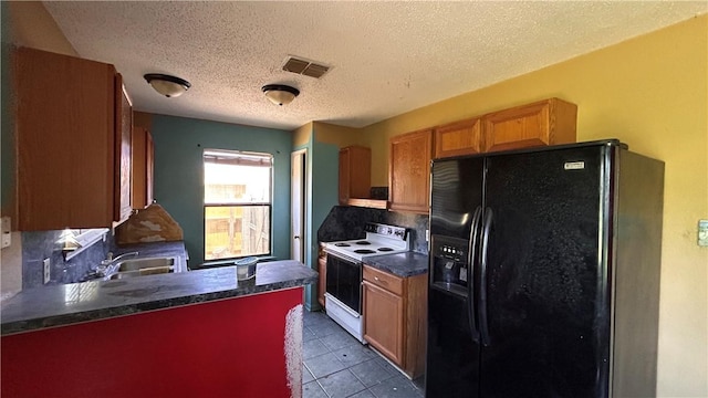 2993 Todd Cir, Ingleside, TX 78362 - kitchen with black fridge, electric stove, dark countertops, a sink, and backsplash