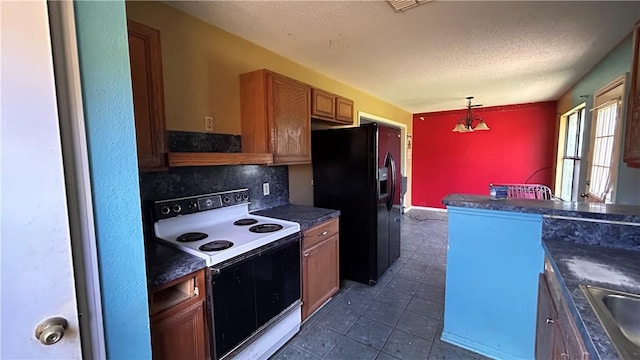 2993 Todd Cir, Ingleside, TX 78362 - kitchen featuring white electric range oven, black refrigerator with ice dispenser, dark countertops, brown cabinets, and a textured ceiling
