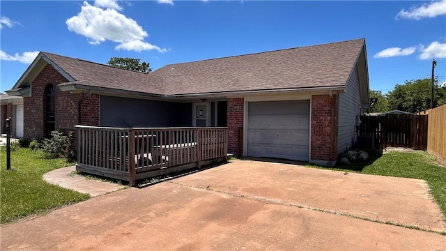 2993 Todd Cir, Ingleside, TX 78362 - ranch-style home with brick siding, a garage, concrete driveway, a shingled roof, and fence