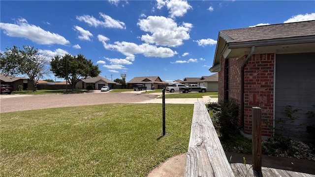 2993 Todd Cir, Ingleside, TX 78362 - view of grassy yard with driveway and a residential view