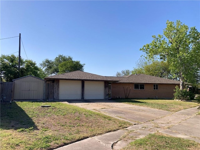 single story home with a garage, a front lawn, driveway, and a shed