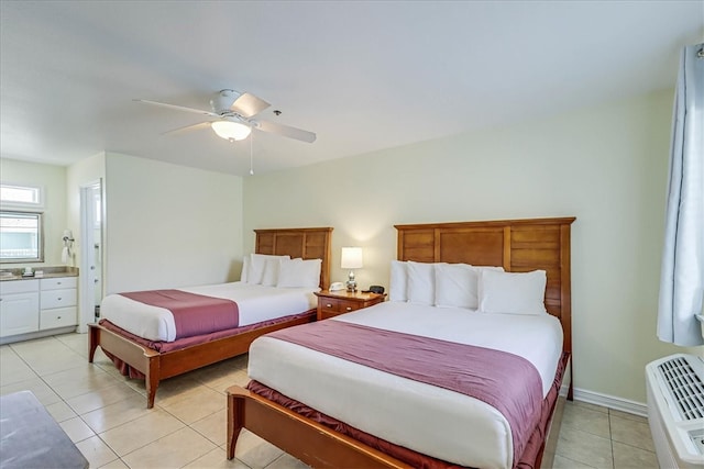 tiled bedroom featuring ensuite bathroom and ceiling fan