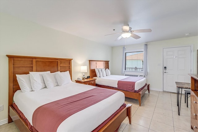 tiled bedroom featuring ceiling fan