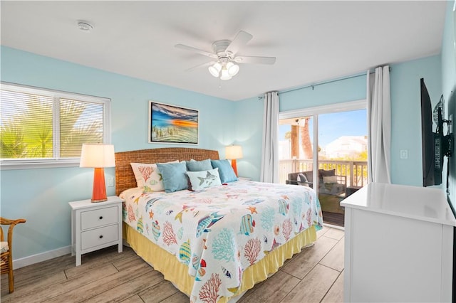 42 Nassau Dr, Rockport, TX 78382 - bedroom with access to exterior, light wood finished floors, ceiling fan, and baseboards