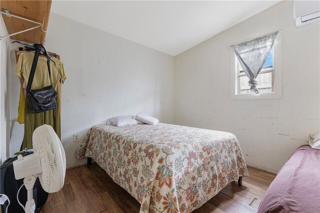 1206 Hibiscus St, Corpus Christi, TX 78405 - bedroom with a wall mounted AC and wood finished floors