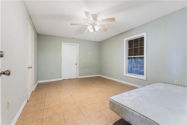 1206 Hibiscus St, Corpus Christi, TX 78405 - unfurnished bedroom with baseboards, a ceiling fan, and light tile patterned floors