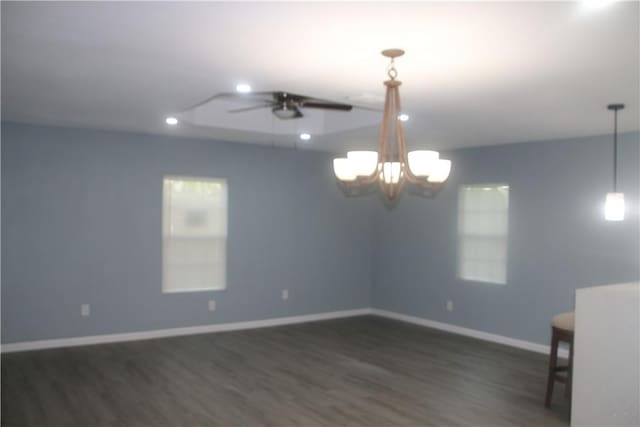 unfurnished room featuring dark hardwood / wood-style floors and ceiling fan with notable chandelier