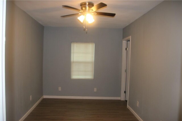 unfurnished room with ceiling fan and dark wood-type flooring