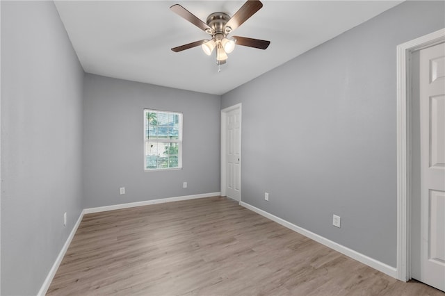 empty room featuring ceiling fan and light hardwood / wood-style flooring