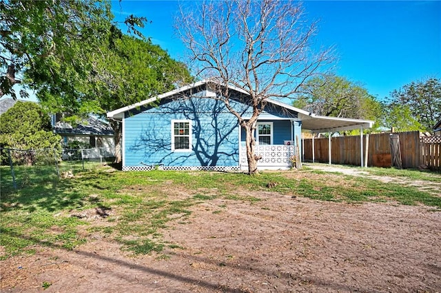 314 Old Robstown, Corpus Christi, TX 78408 - rear view of property with a fenced backyard, an attached carport, and dirt driveway