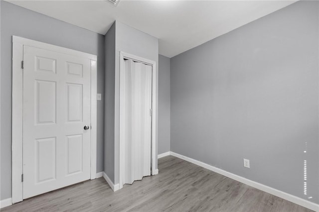 314 Old Robstown, Corpus Christi, TX 78408 - unfurnished bedroom featuring light wood-type flooring, baseboards, and a closet