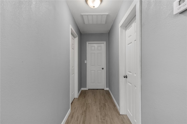 hallway with light wood-type flooring