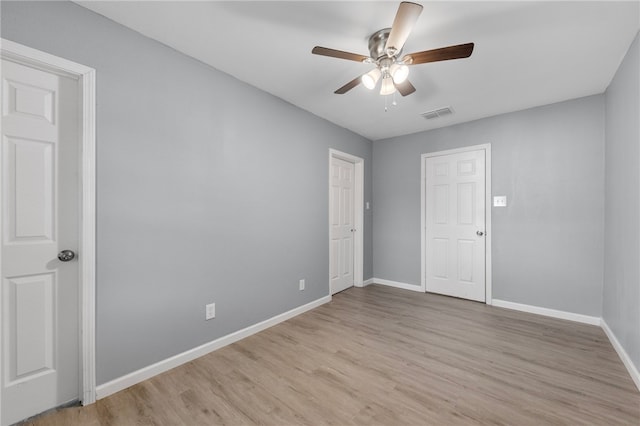 empty room with light hardwood / wood-style flooring and ceiling fan