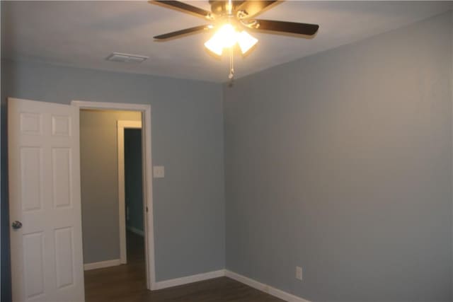 unfurnished room featuring dark hardwood / wood-style flooring and ceiling fan