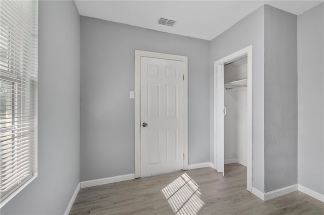 unfurnished bedroom featuring a closet and light wood-type flooring