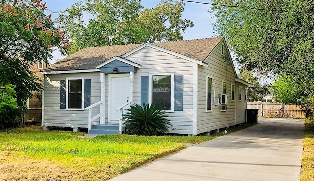 bungalow-style home with a front lawn