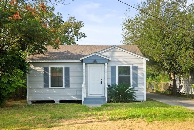 bungalow-style home with a front lawn