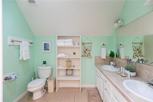 bathroom featuring toilet, vanity, tile patterned floors, and lofted ceiling