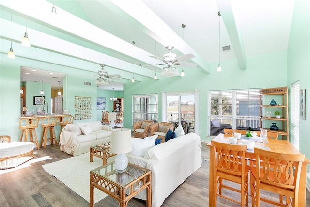 living room featuring beam ceiling, ceiling fan, and wood-type flooring