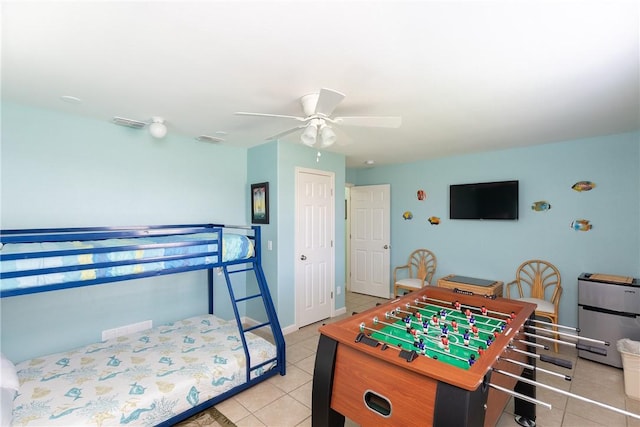 bedroom with ceiling fan, a closet, and light tile patterned floors