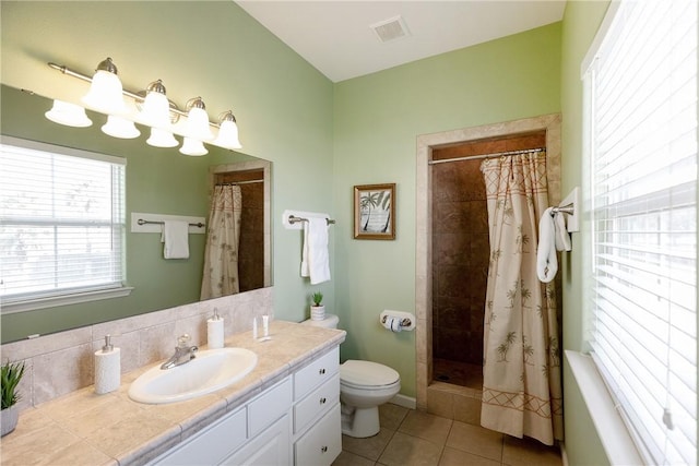 bathroom with backsplash, walk in shower, vanity, tile patterned flooring, and toilet