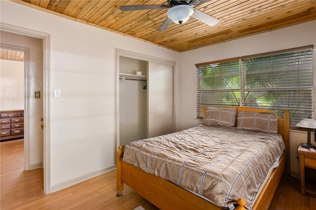 bedroom featuring a closet, light wood-type flooring, wooden ceiling, and ceiling fan