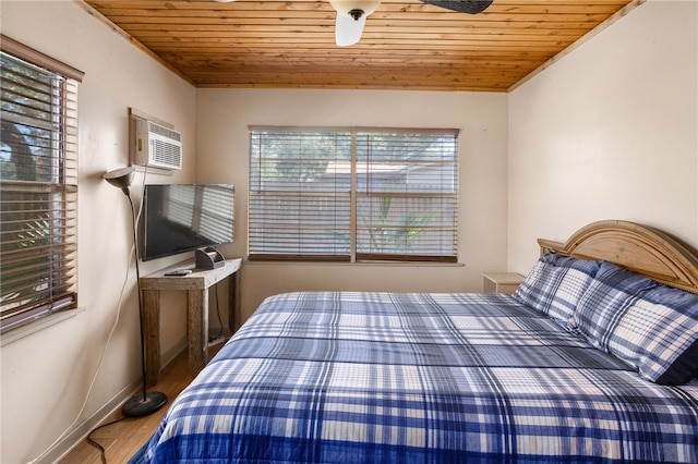 bedroom with an AC wall unit, multiple windows, and wooden ceiling