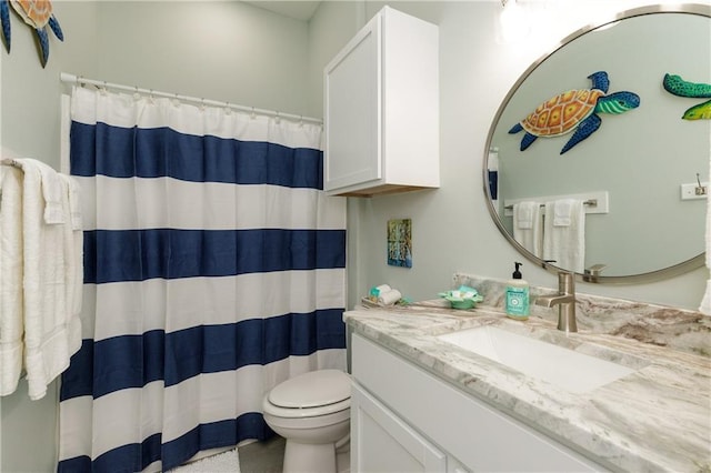 bathroom featuring walk in shower, vanity, and toilet