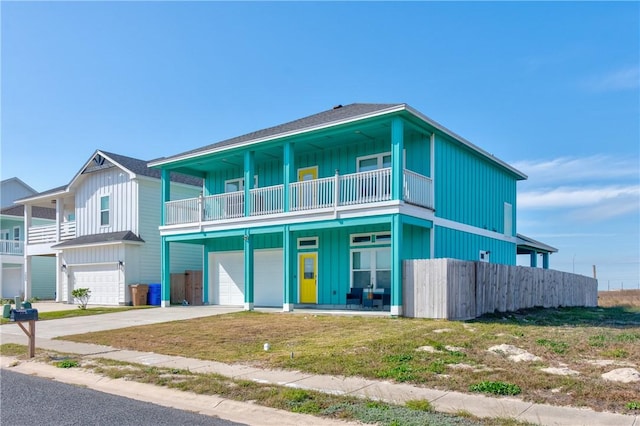 view of front of house with a balcony, a garage, and a front yard