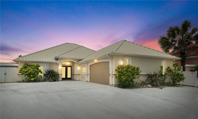 16029 Cuttysark St, Corpus Christi, TX 78418 - single story home featuring a garage, stucco siding, a metal roof, and concrete driveway