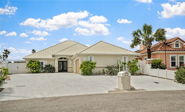 16029 Cuttysark St, Corpus Christi, TX 78418 - view of front facade featuring french doors, a gate, stucco siding, driveway, and a garage